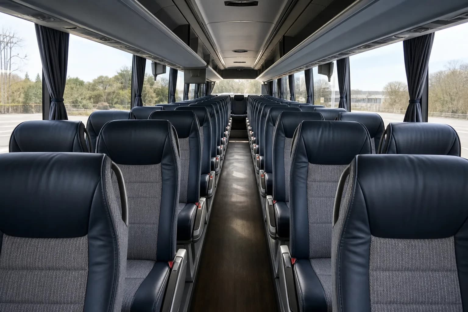 Centre aisle of a motorcoach lined with high-back reclining seats