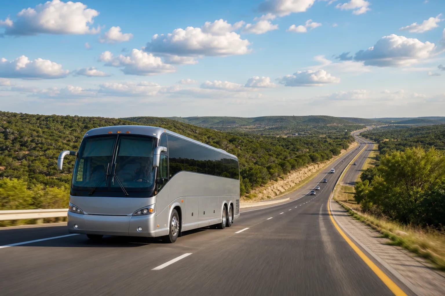 Coach travelling a divided highway through green rolling hills